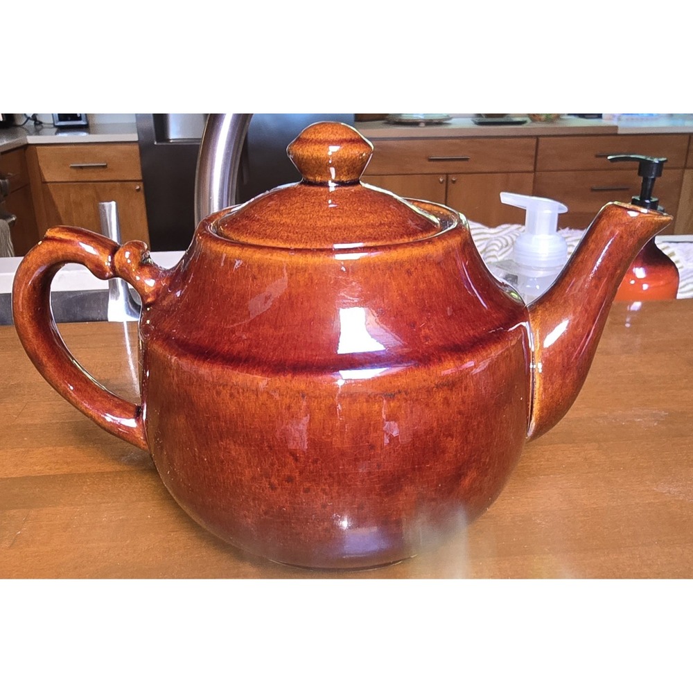 Vintage Red Brown Pottery teapot featuring a brown drip glaze.